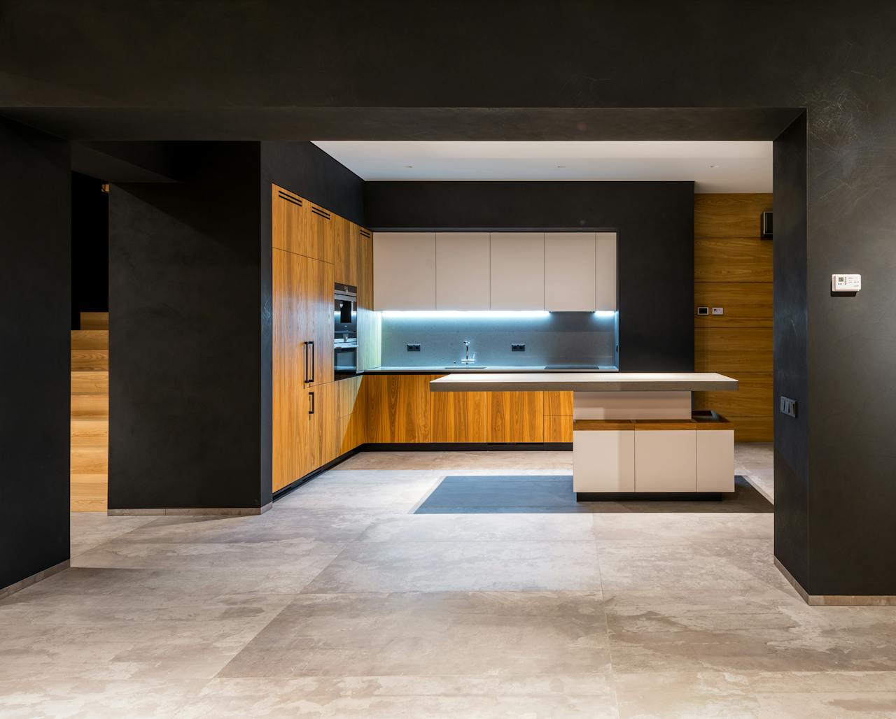 Interior of modern cottage with marble floor and spacious kitchen with wooden furniture and floating tabletop